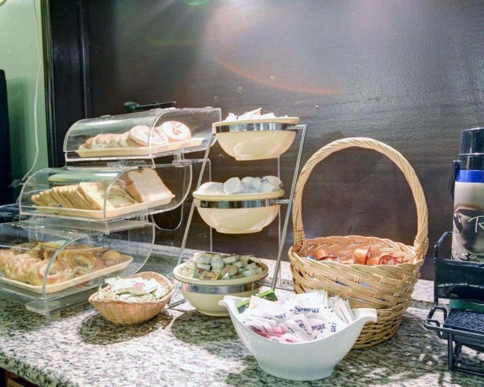 a display of bread and other food items on a counter at Quality Inn & Suites Airport in Austin