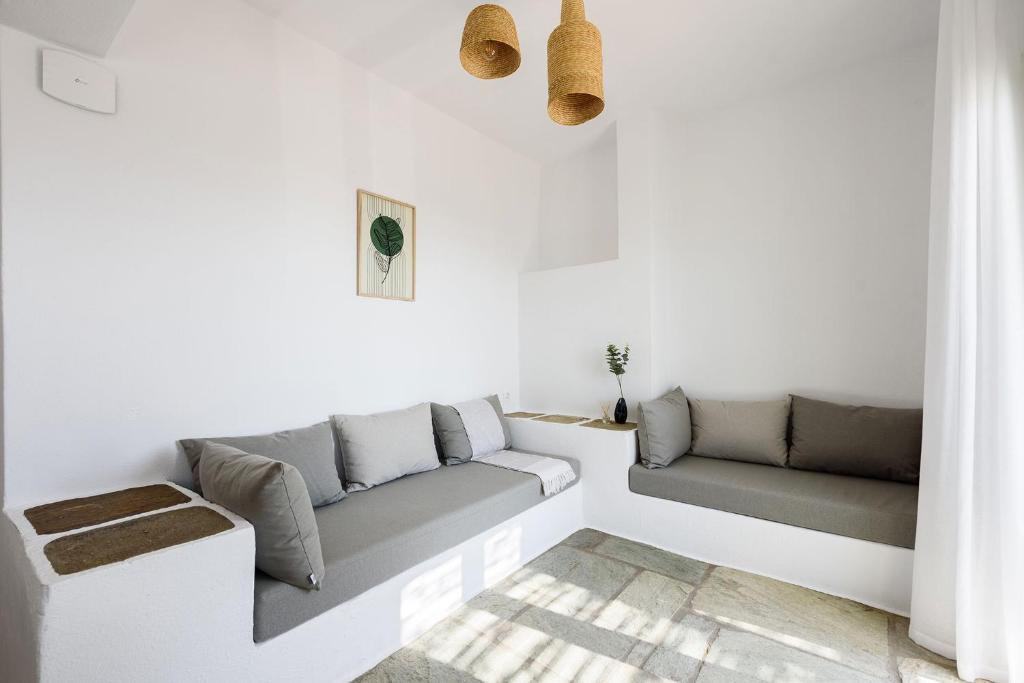 a living room with white walls and a couch at Phaedrus Living Paros Cycladic Residences 6 in Kampos Paros