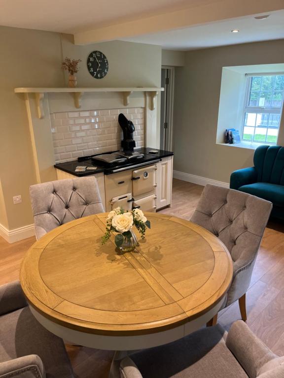 a dining room with a wooden table and chairs at The Residence at Lough Key - Luxury by the Water in Knockvicar Bridge