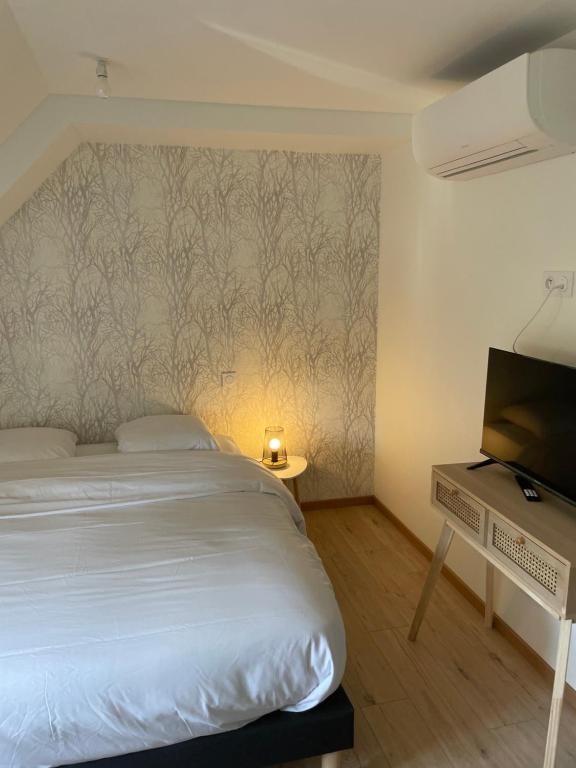 Postel nebo postele na pokoji v ubytování L auberge du Moulin Eschviller