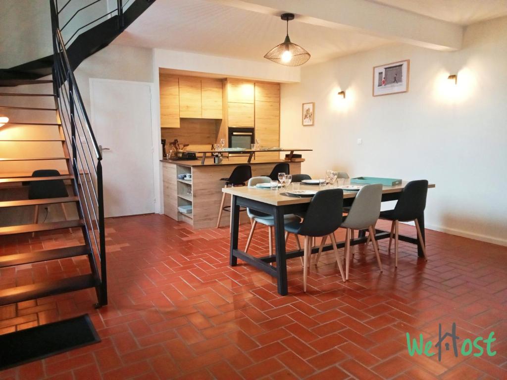 une salle à manger avec une table et des chaises et une cuisine dans l'établissement Modern Triplex - city center, à La Rochelle