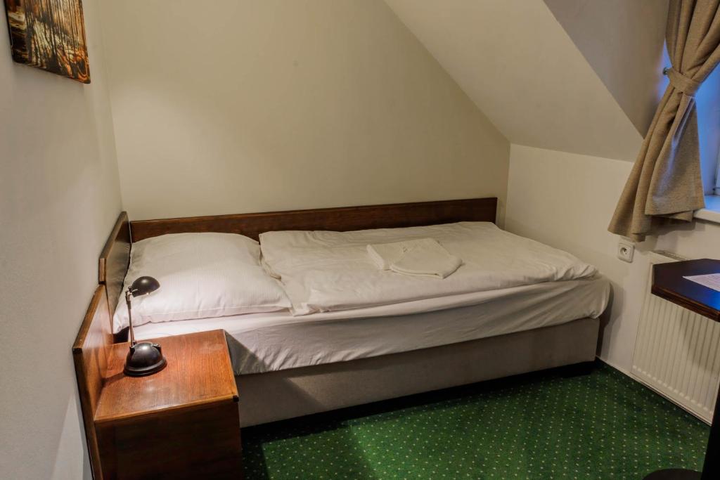 Postel nebo postele na pokoji v ubytování Bechnerův statek