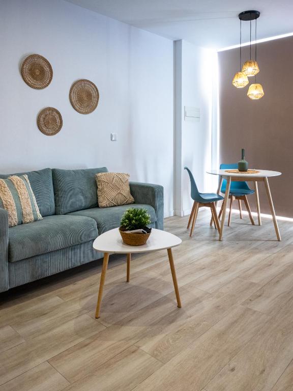 a living room with a couch and a table at Boho Beach Flats in Valencia