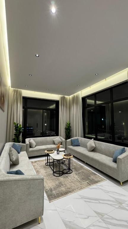 a large living room with couches and a table at شاليه لدن in Hail