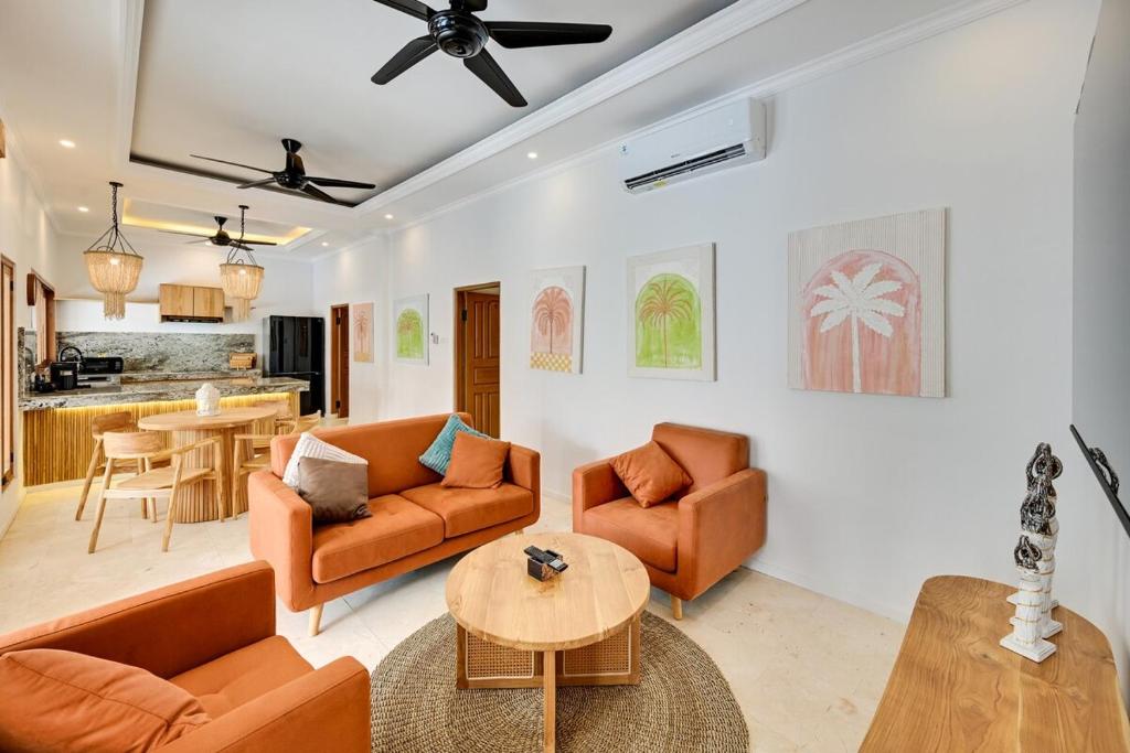 a living room with two couches and a table at Villa Mawali in Legian