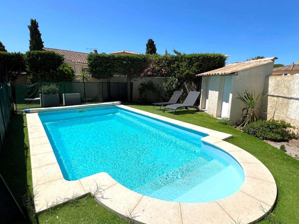 a swimming pool in the backyard of a house at Villa 3 étoiles avec piscine privée, 500m de la plage, 4 chambres pour 6-8 pers. au Grau-du-Roi - FR-1-307-157 in Le Grau-du-Roi