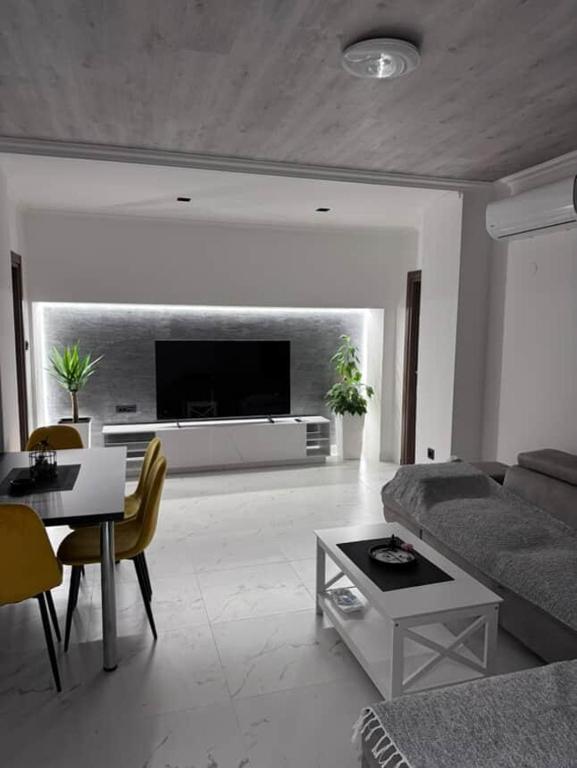 a living room with a couch and a table at Apartman Andrija in Igalo
