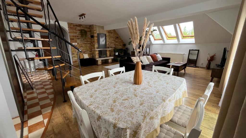 a dining room with a table with a vase on it at Apartament Zamoście in Zamość