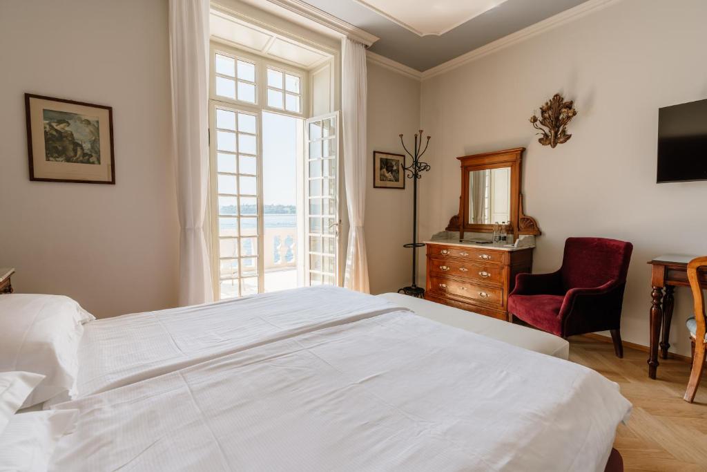 Postel nebo postele na pokoji v ubytování Hotel Monte Baldo e Villa Acquarone