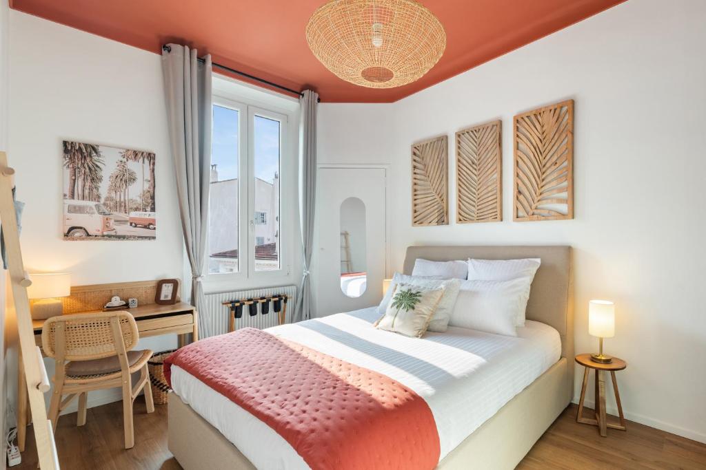 a bedroom with a bed and a desk and a window at Suite design - 3 min Palais & Croisette - Central in Cannes