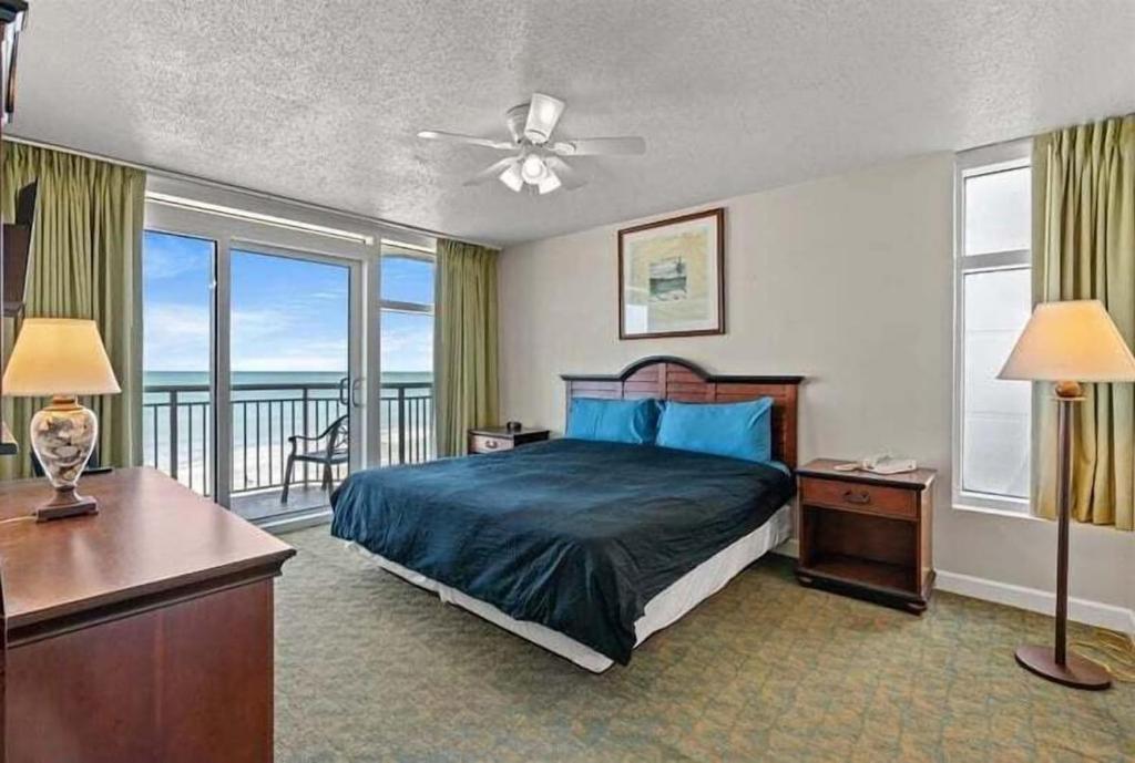 a bedroom with a bed and a view of the ocean at Spacious 2 bedroom Direct Ocean Front Condo, Corner Unit, Balconies HSS 5th FL in Myrtle Beach