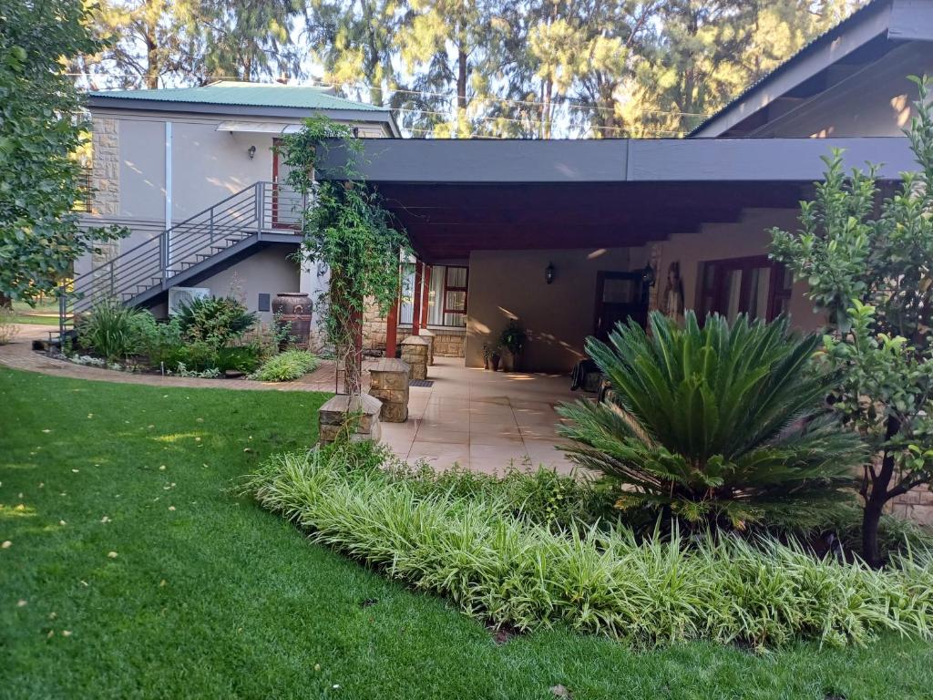 a house with a walkway in front of a yard at 109 Mauser Avenue in Pretoria