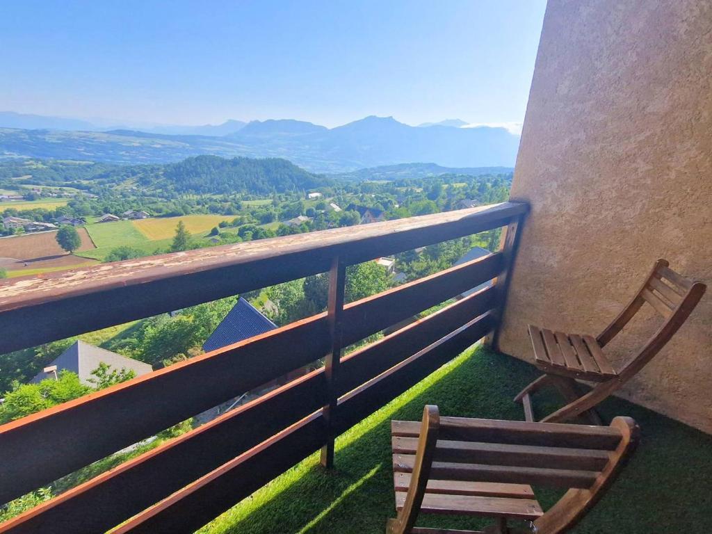 a wooden chair sitting on a balcony with a view at Duplex 6 pers, animaux admis, balcon sud, Chaillol 1600 - FR-1-393-182 in Saint-Michel-de-Chaillol