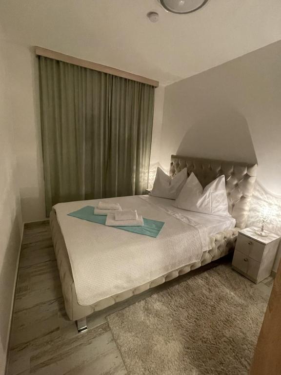 a bedroom with a bed with a star on it at Smart Bijela in Bijela