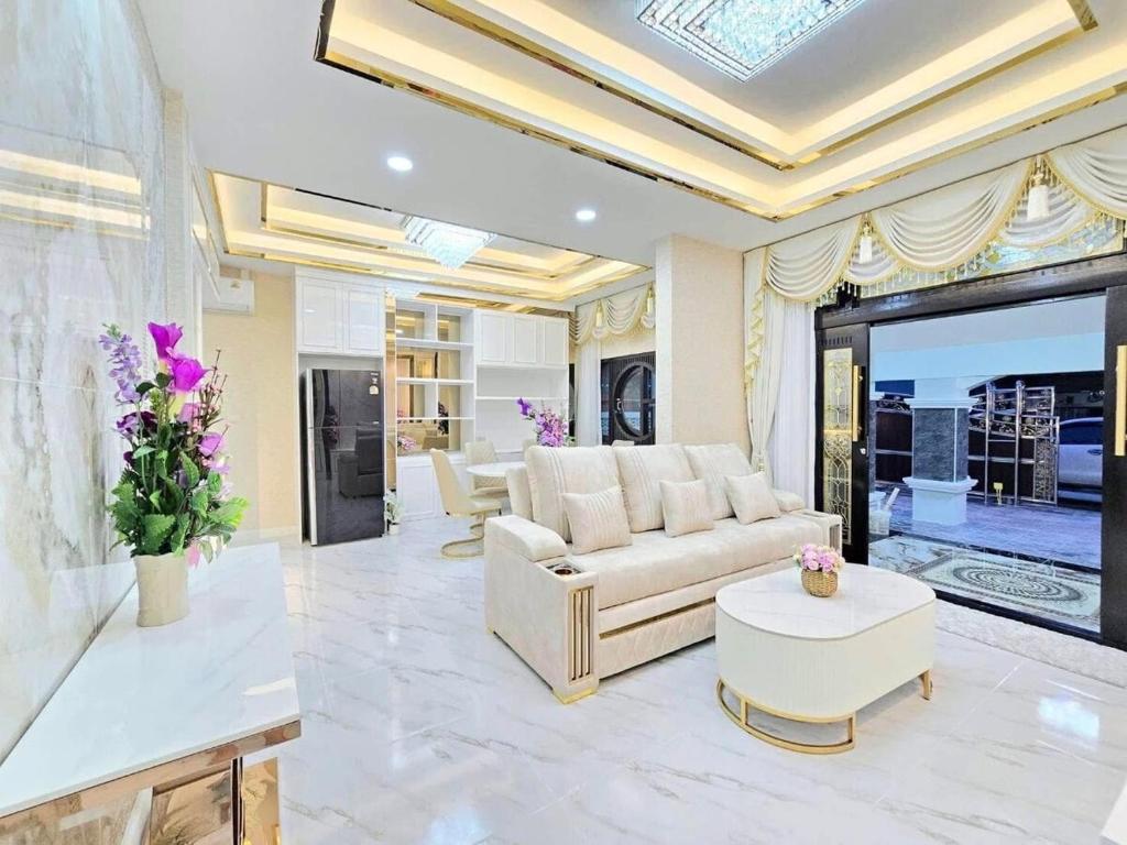 a living room with a couch and a table at Marina Villa, North Pattaya in Pattaya North