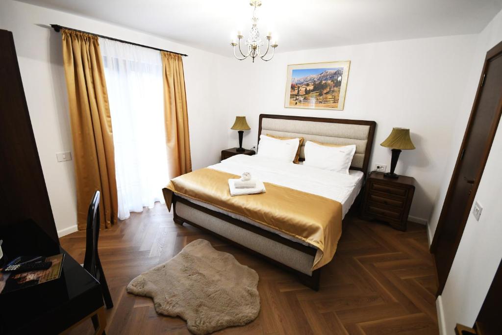 una camera da letto con un letto e un lampadario di Branovia a Bran