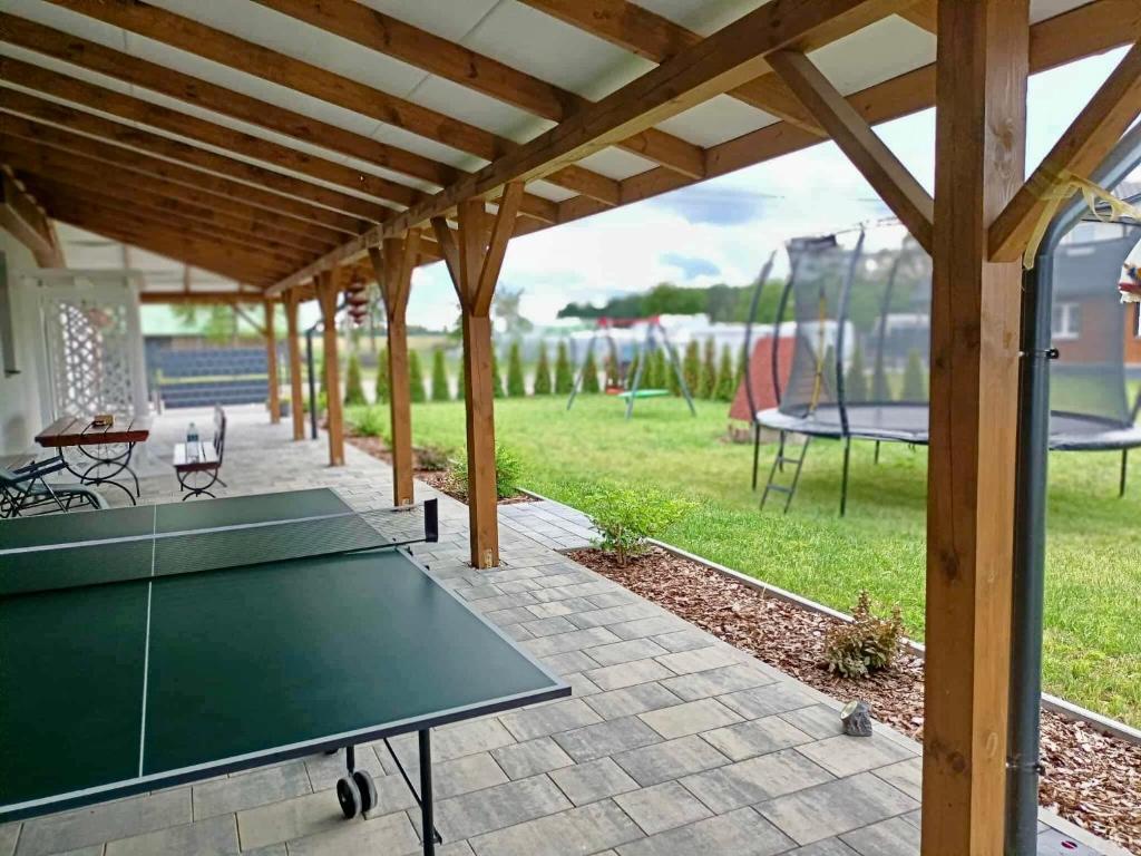 Mirabelka - domek في Podostrówek: طاولة بينج بونغ في جناح مع طاولة بينج بونغ