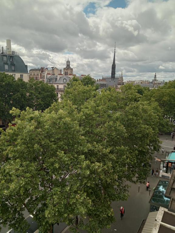 a view of a city with trees and buildings at Hotel Modern Est in Paris
