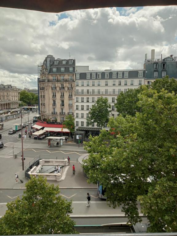a view of a city with buildings and trees at Hotel Modern Est in Paris