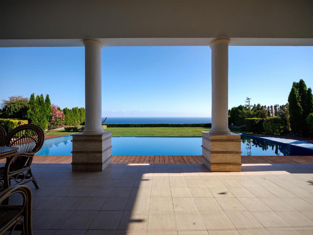 a view from the patio of a house with a pool at Luxury Villa with Pool- 4 Bedrooms in BlackSeaRama by Flat Mаnаger in Varna City