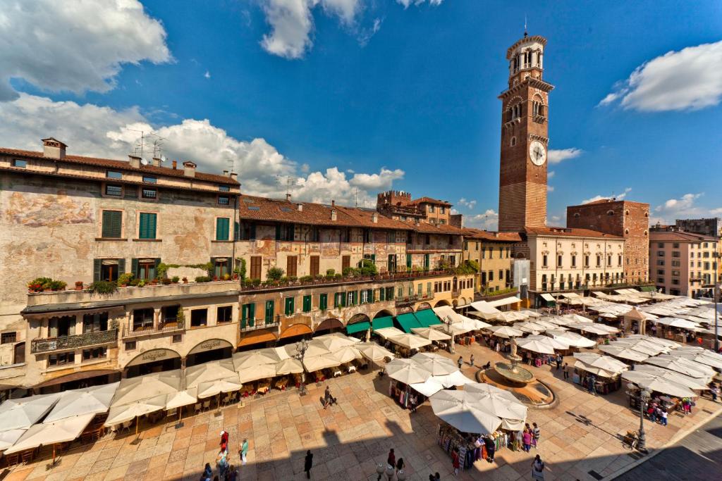 a city with a clock tower and a market at Residenza Madonna Verona in Verona