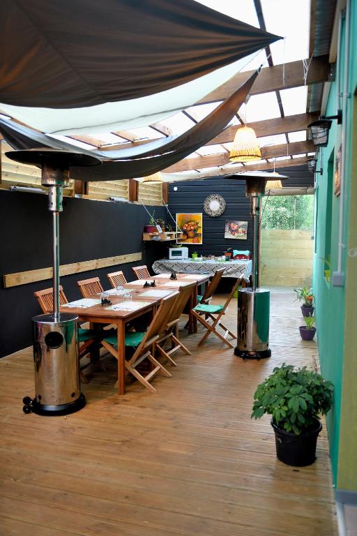 a restaurant with a long table and chairs in a room at La Maison Verte in Le Tampon