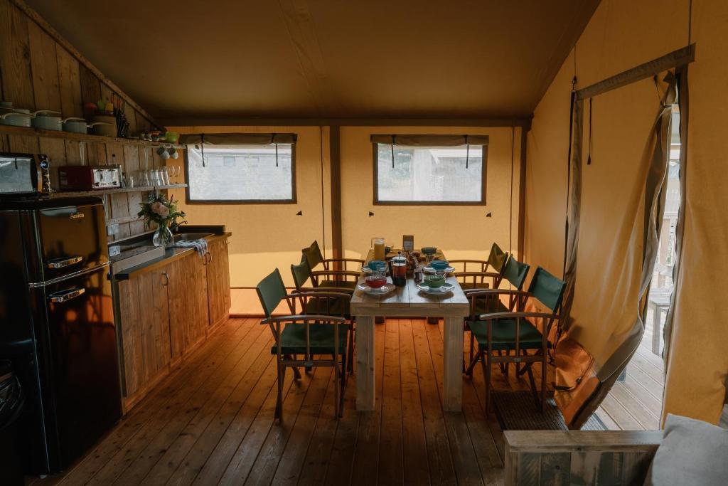 a kitchen with a table and chairs in a room at Butterfly Riverdale Yorkshire in West Tanfield