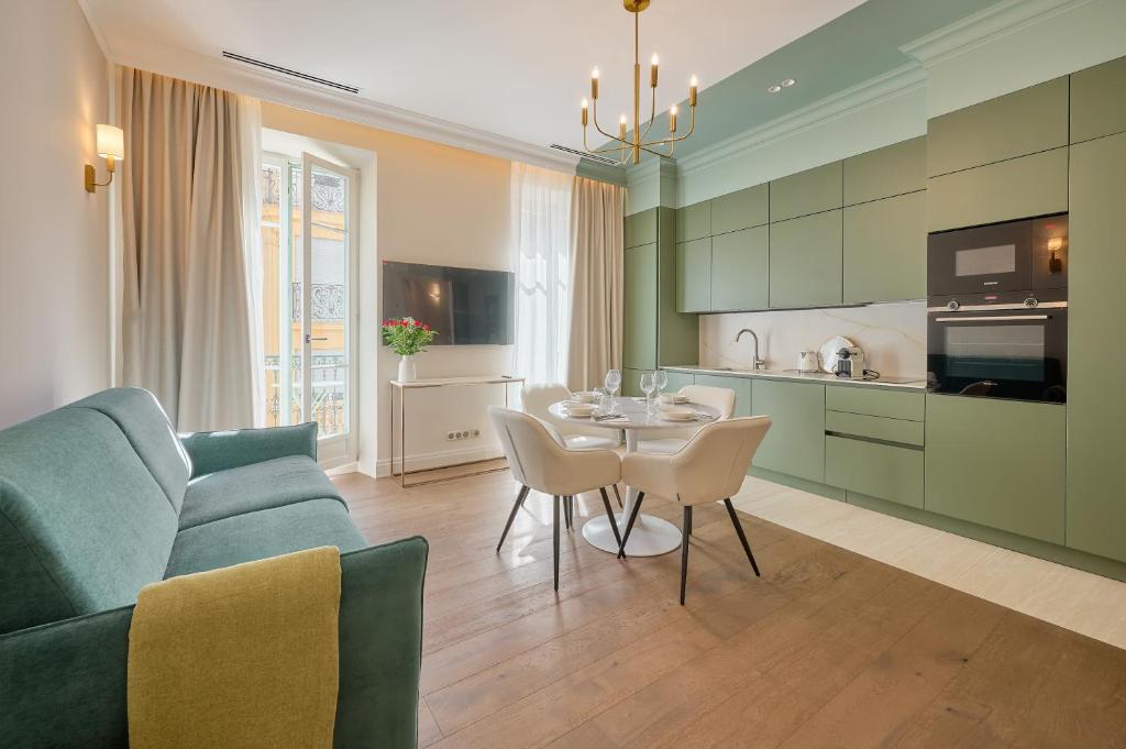 a kitchen and living room with a couch and a table at Aparthotel 9 ALBERTI Nice Centre in Nice