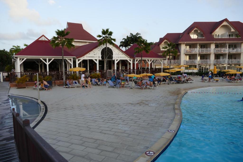 a resort with a swimming pool and a hotel at Résidence P&V studio PREMIUM TOBAGO 24 in Sainte-Luce