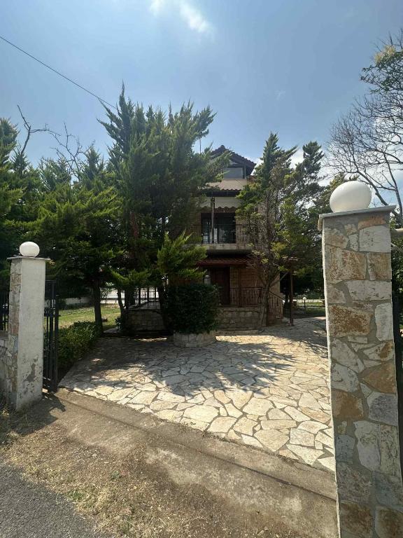 a house with a gate in front of it at Villa canty in Nea Potidaea