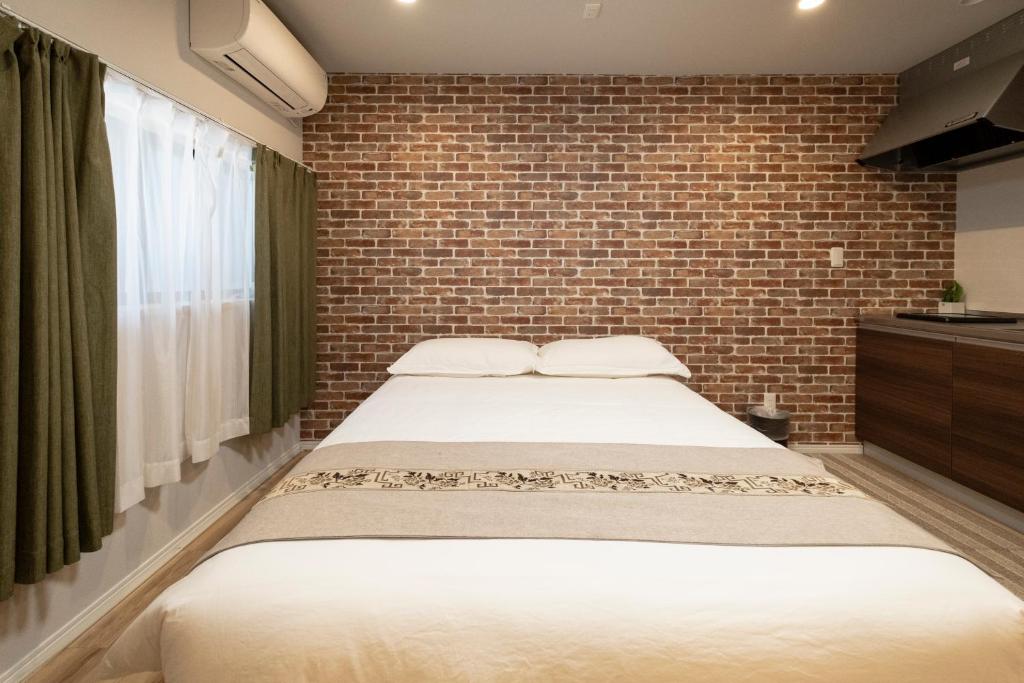 Giường trong phòng chung tại 安楽居