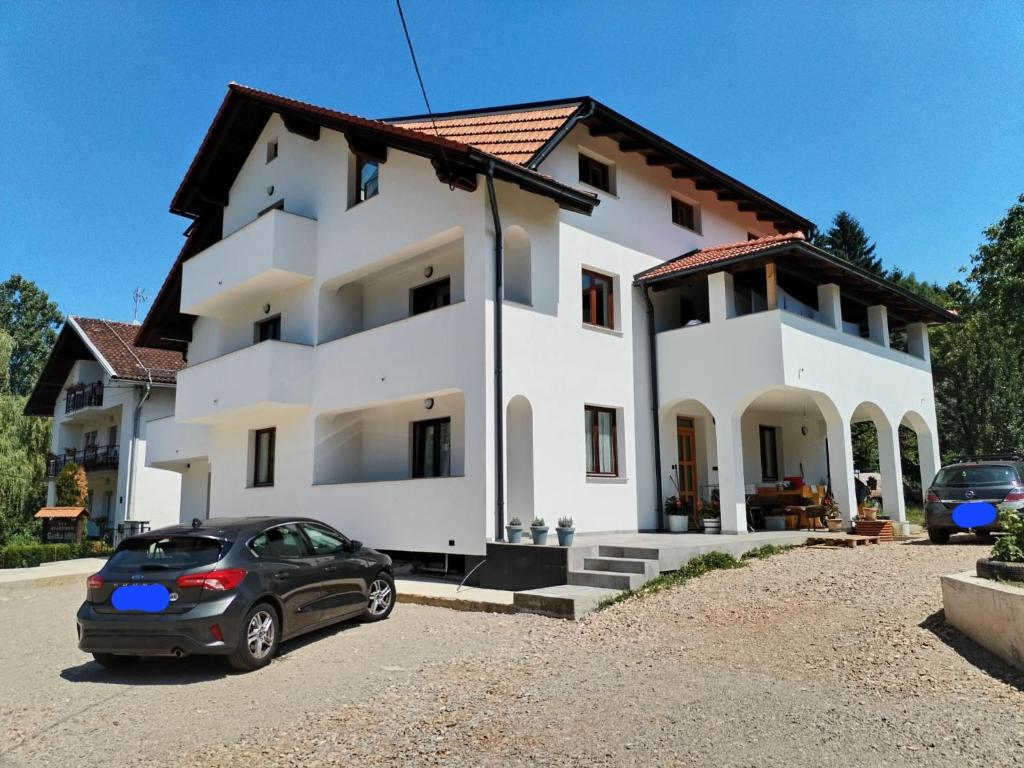 a house with a car parked in front of it at Villa Roko in Ličko Lešće