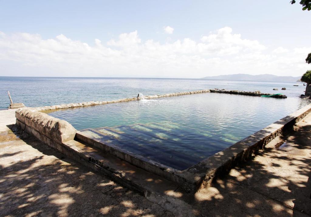 a swimming pool in the middle of the ocean at Eagle Point Beach and Dive Resort in Mabini