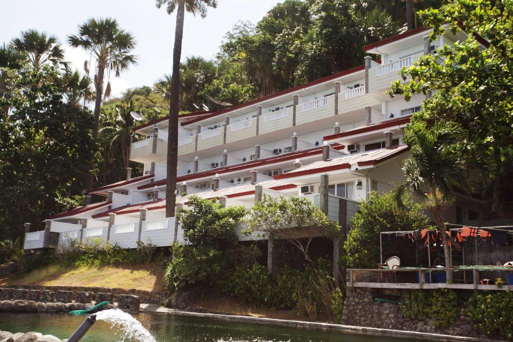 a building on the side of a river at Eagle Point Beach and Dive Resort in Mabini