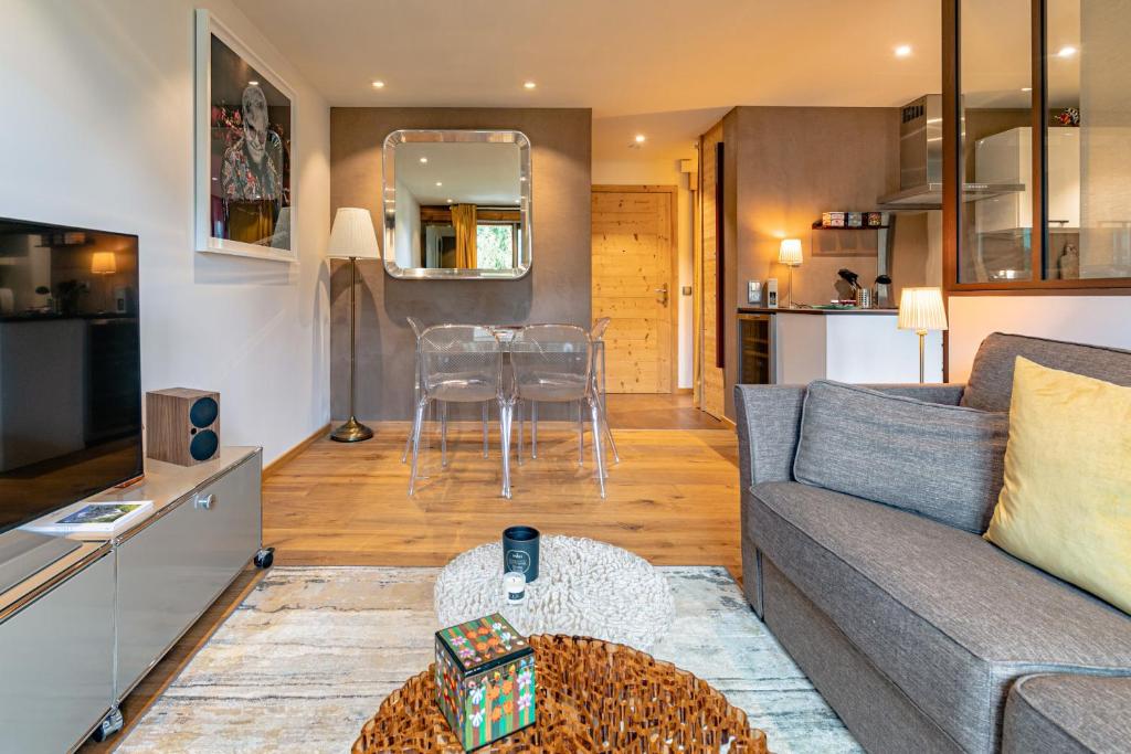 a living room with a couch and a table at Arly in Megève