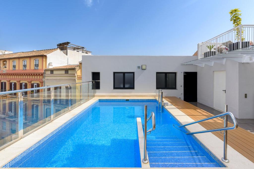a swimming pool on the roof of a building at Exe Málaga Museos in Málaga