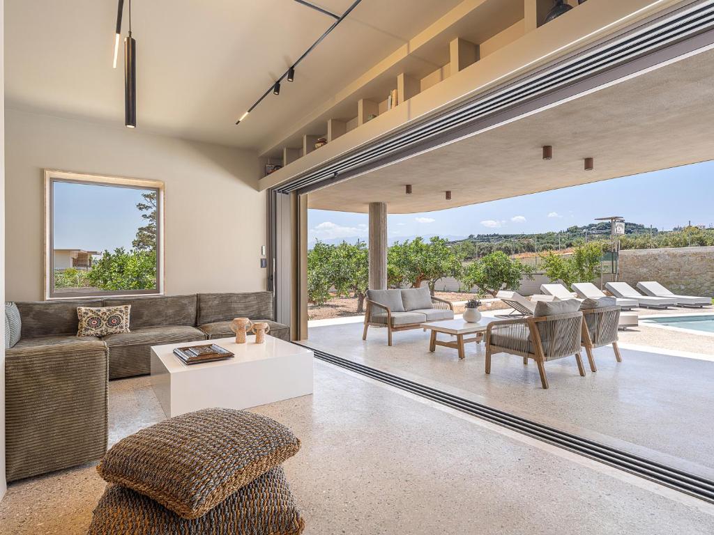 a living room with a couch and a table at Villa Portokalea in Maleme