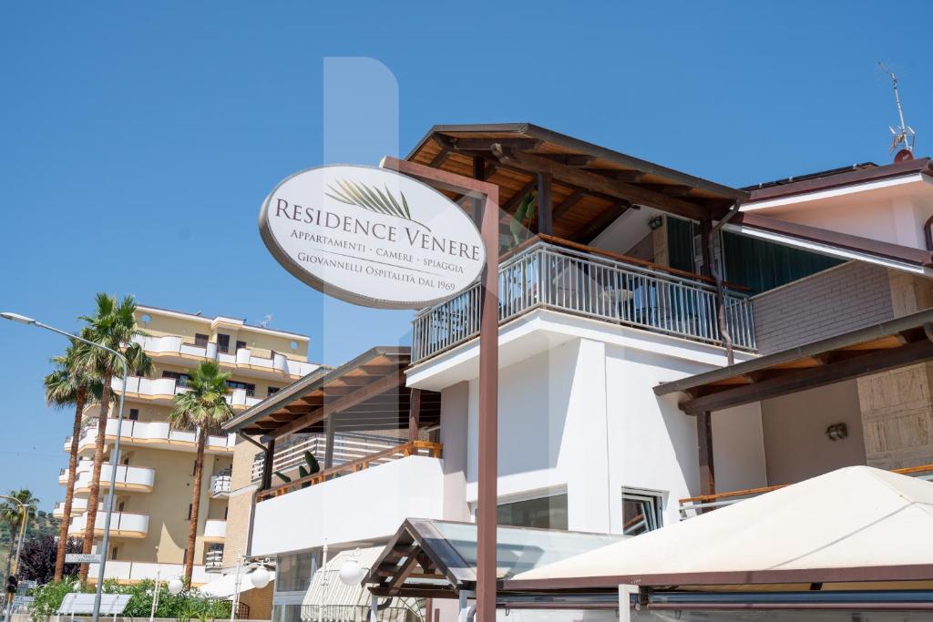 a sign in front of a building at Homiday - Residence Venere in Alba Adriatica