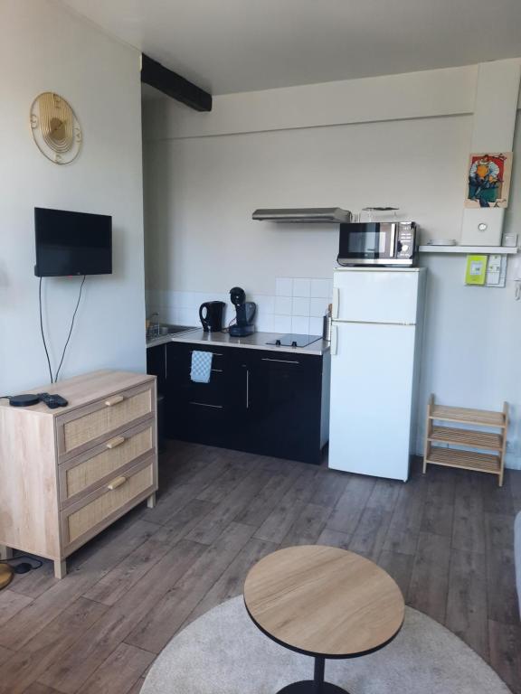 a kitchen with a white refrigerator and a table at Rent studio 25 m2 city center, Brest in Brest