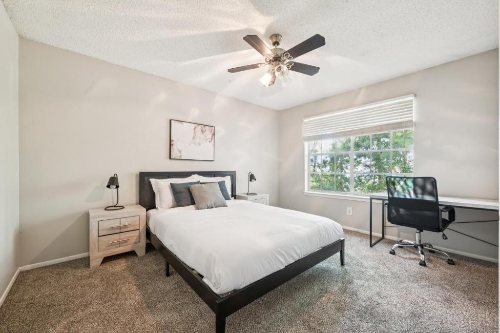 a bedroom with a bed and a ceiling fan at The Davis 1824 I Spacious 2 Bed 2 Bath in Huntsville