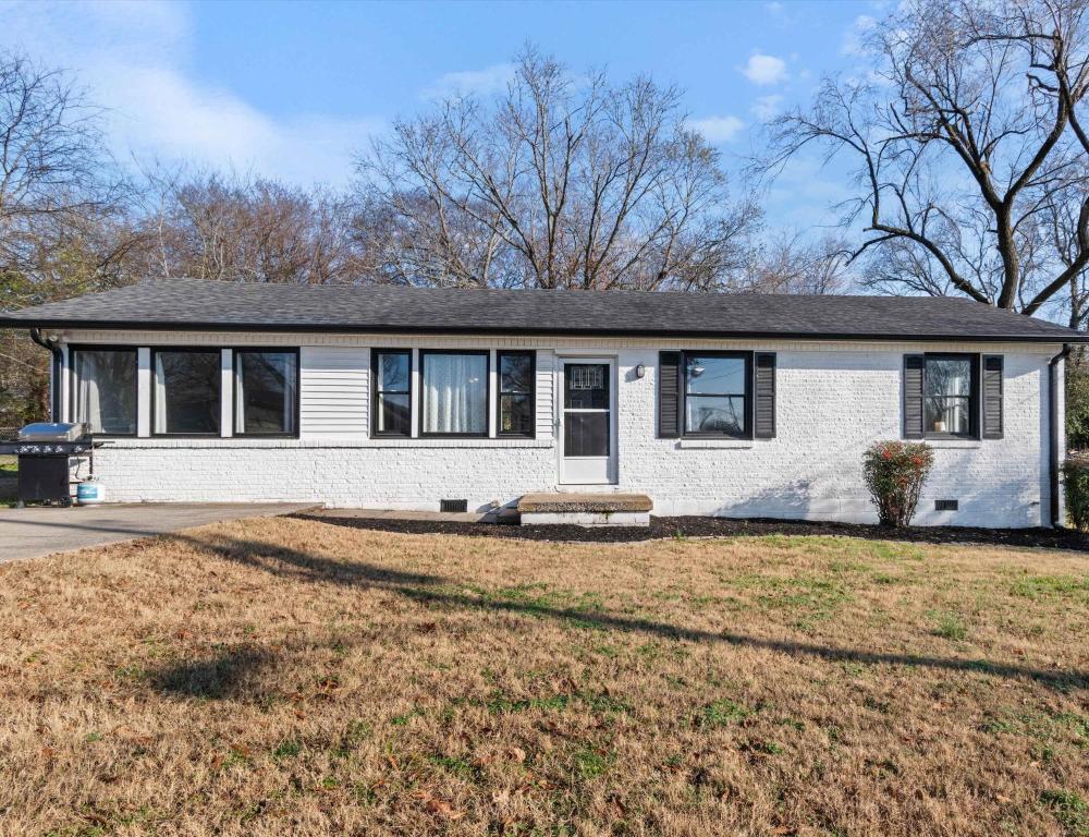 a white brick house with a large yard at Franklin Retreat - Sleeps 4 in Franklin