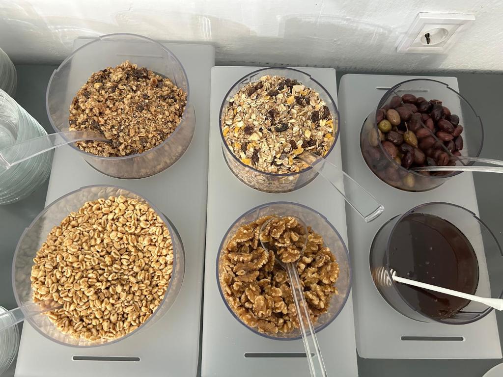 a group of four bowls of food in a refrigerator at Aliston Hotel Thassos in Skala Potamias