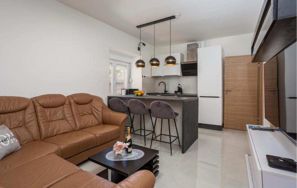 a living room with a couch and a kitchen at Gorgeous Apartment In Rijeka With Wifi in Rijeka