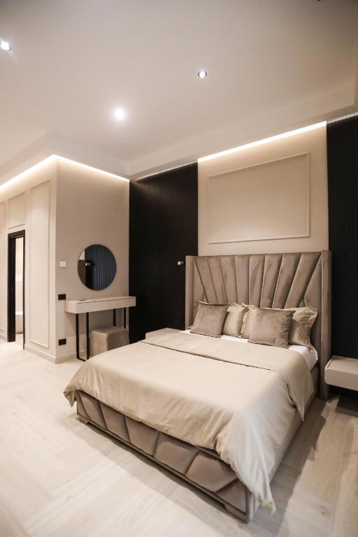 a bedroom with a large bed and a table at LUNA Gallery Suites in Naples