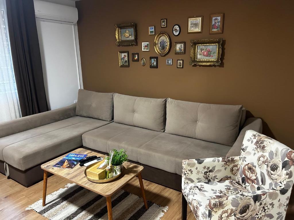 a living room with a couch and a table at Apartment Liriq - Free Parking in Sarajevo