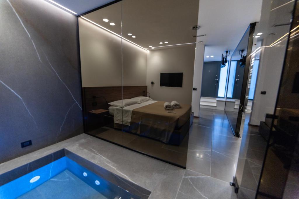 a bedroom with a bed and a tub in a room at VS LUXURY SUITE with SPA in Bari
