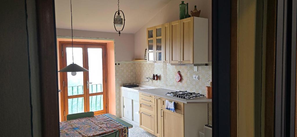a kitchen with a sink and a stove top oven at La Casa del Tramonto in Vellano