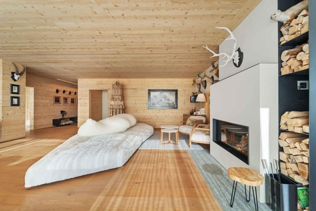a bedroom with a large bed and a fireplace at Chesa Wolf Zuoz in Zuoz