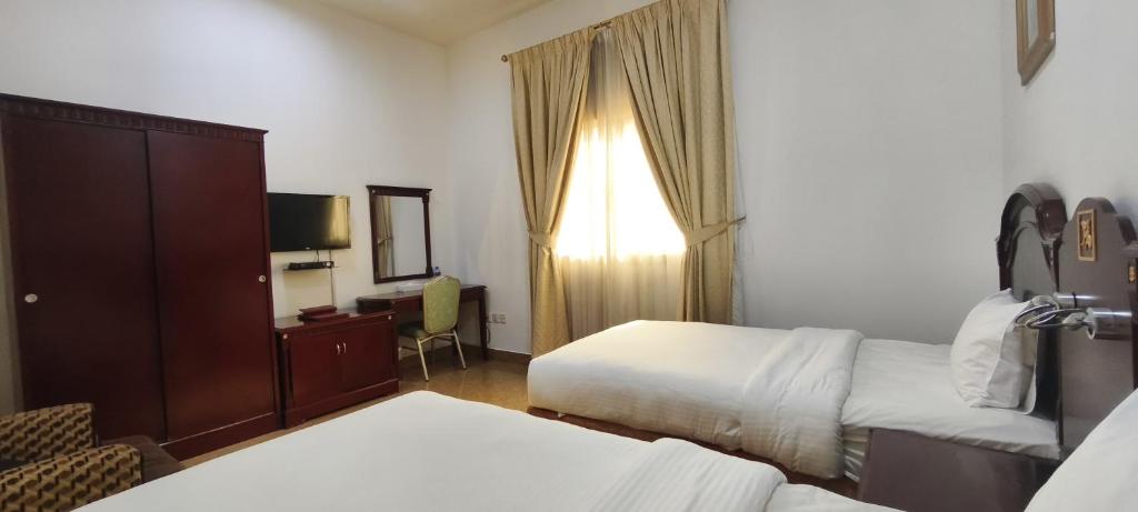 Postel nebo postele na pokoji v ubytování Safeer International Hotel By Brothers International
