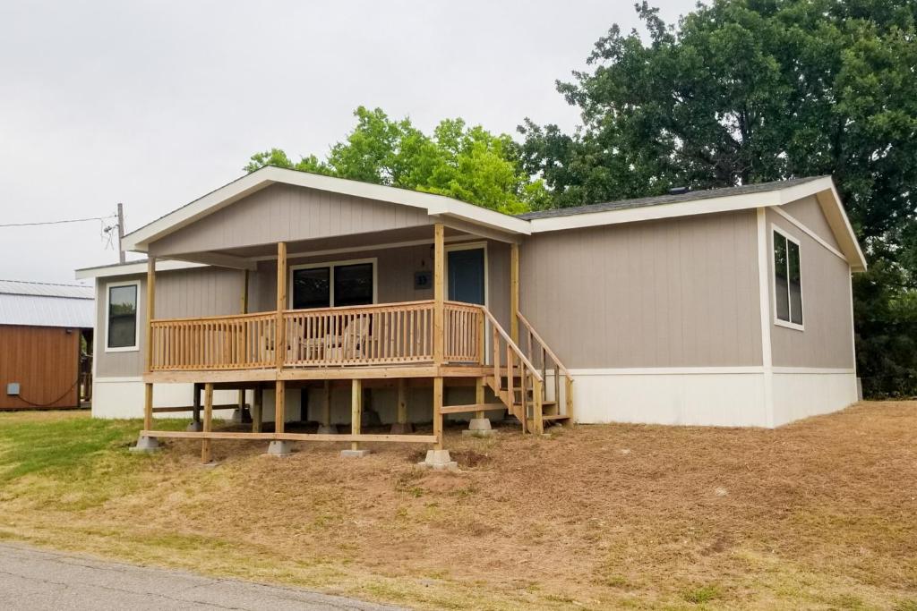 a house with a large deck on the side of it at Lakefront Texoma Harbor - 33 in Mead